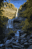 Kaaterskill Falls. The falls is mentioned once in Washington Irving’s 1819 story, “Rip Van Winkle”. You can see two people standing on the middle level of the falls at left.
